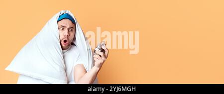 Overslept for work. Emotional man in terror looks at clock Stock Photo