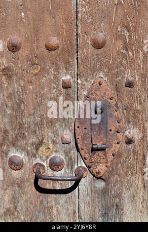 Rusty iron lock on an old wooden door Stock Photo
