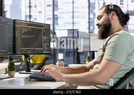 IT worker writing code, conducting experiments and tests to optimize machine learning models for performance and accuracy. Man in software engineer office position analyzing data Stock Photo