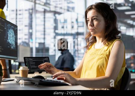 Software engineer doing job, creating machine learning models that can process and analyze data to automate decision making processes. Focused IT specialist programming in workspace using PC Stock Photo