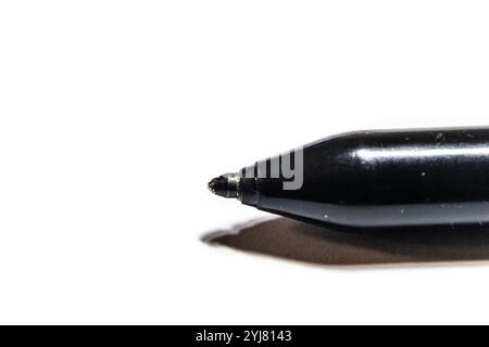 Close up of a black ballpoint pen on a white background with copy space. Prepping to write notes. Thinking. Blank space. Stock Photo