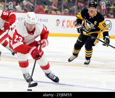 Pittsburgh, United States. 13th Nov, 2024. Detroit Red Wings left wing Lucas Raymond (23) crosses the blue line as Pittsburgh Penguins center Sidney Crosby (87) follows the play at PPG Paints Arena in Pittsburgh on Wednesday, November 13, 2024. Photo by Archie Carpenter/UPI. Credit: UPI/Alamy Live News Stock Photo