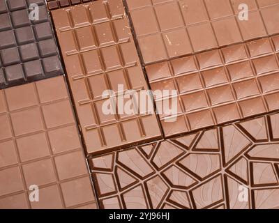 Chocolate bar background. Dark and milk chocolate filling the frame. Assorted candy in brown color from the cocoa ingredient. Stock Photo