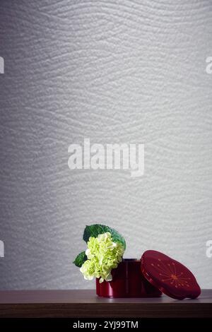 Vessels and small white flowers on the table Stock Photo
