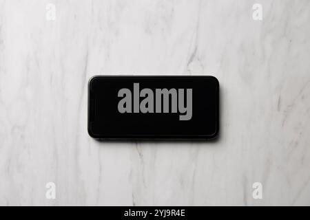 Smartphone placed on marble baking sheet Stock Photo