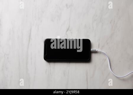 Smartphone placed on marble baking sheet Stock Photo