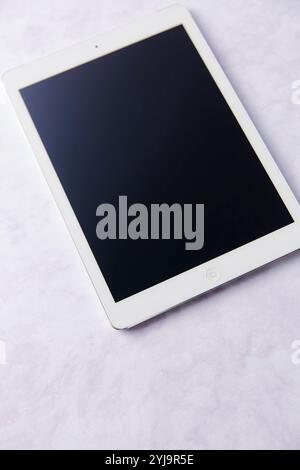 Tablet device with white frame placed at an angle Stock Photo