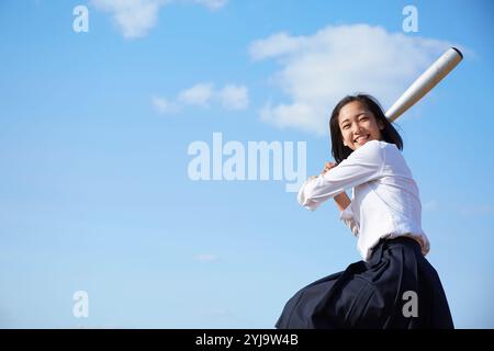 High school girls swinging baseball bats Stock Photo