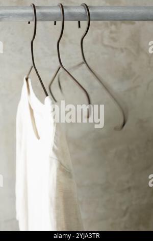 Hangers and clothes on silver rack Stock Photo - Alamy