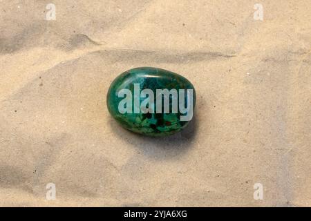 Natural chrysocolla gemstone on craft paper textured background close up Stock Photo