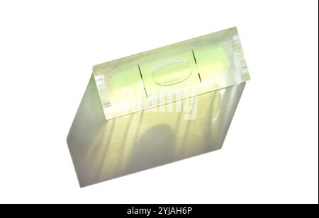 Precision tool with bubble level indicator casting shadow on white background. Stock Photo