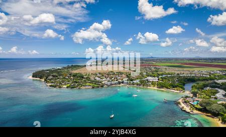 This aerial photograph captures a stunning tropical island amidst the vastness of the Indian Ocean. Stock Photo