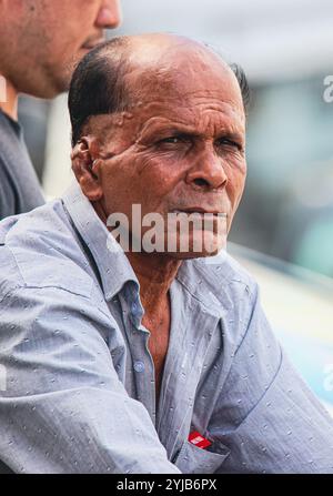Two men, one local to Mauritius, sitting next to each other on a street. Stock Photo