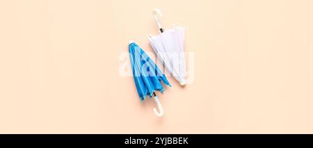 Different umbrellas on beige background, top view Stock Photo