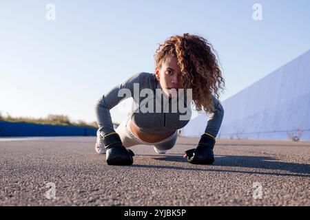 latin sports woman in sportswear doing push ups Stock Photo