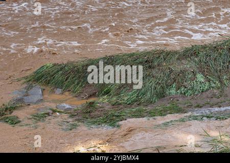 Fast moving muddy water in Mission Creek during a rainstorm Santa 