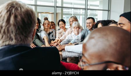 A diverse group of professionals working together, showing team spirit and collaboration to achieve a successful performance. Stock Photo