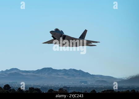 An F-22 Raptor assigned to Nellis Air Force Base, takes off to participate in a memorial flyover for Retired U.S. Air Force Col. Gail Peck at Nellis A Stock Photo