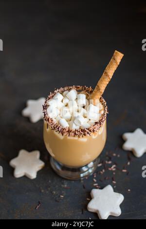 Christmas Hot Latte coffee with Small Marshmallows on dark Black background. selective focus. closeup view. Vertical photo. Stock Photo
