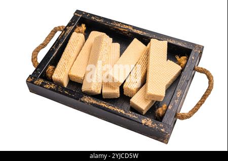 Wafer stick biscuits with vanilla cream in wooden tray isolated on white background. top view. Stock Photo
