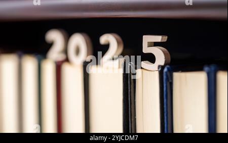 Número 2025 de madera sobre libros de una estantería de una biblioteca Stock Photo