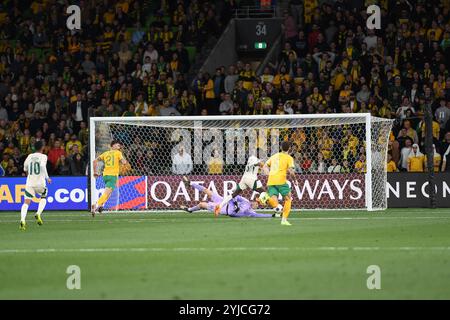 MELBOURNE, AUSTRALIA. 14th November 2024. Pictured: Joe Gauci of Australia dives for the ball after a strike on the Socceroos goal by Marwan Al Sahafi of Saudi during the Group C Australia vs Saudi Arabia AFC World Cup Qualifiers 3rd Round from Melbourne's Rectangular Stadium at AAMI Park on the 14th November 2024. Credit: Karl Phillipson/Alamy Live News Stock Photo