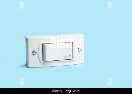 Light switch on a light blue background with copy space Stock Photo