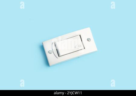 Light switch on a light blue background with copy space Stock Photo