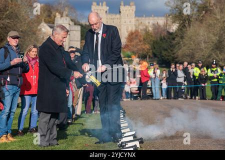 Windsor, UK. 14th November, 2024. Ray Butler of Shellscape Pyrotechnics supervises a member of the public in firing a small cannon during a 21-gun salute on the Long Walk in front of Windsor Castle to mark King Charles III's 76th birthday. An invitation was issued to local children to help celebrate the traditional gun salute for King Charles III. Credit: Mark Kerrison/Alamy Live News Stock Photo