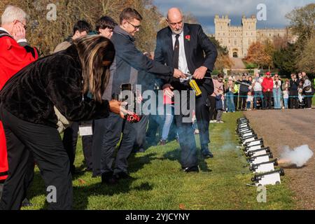 Windsor, UK. 14th November, 2024. Ray Butler of Shellscape Pyrotechnics supervises a member of the public in firing a small cannon during a 21-gun salute on the Long Walk in front of Windsor Castle to mark King Charles III's 76th birthday. An invitation was issued to local children to help celebrate the traditional gun salute for King Charles III. Credit: Mark Kerrison/Alamy Live News Stock Photo