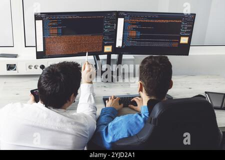 IT Programmer Working on Desktop Computer. Male Specialist Creating Innovative Software Engineer Developing App, Program, Video Game. Terminal with Co Stock Photo