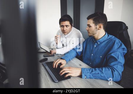 IT Programmer Working on Desktop Computer. Male Specialist Creating Innovative Software Engineer Developing App, Program, Video Game. Terminal with Co Stock Photo