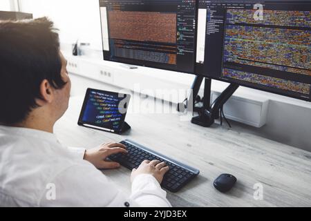 IT Programmer Working on Desktop Computer. Male Specialist Creating Innovative Software Engineer Developing App, Program, Video Game. Terminal with Co Stock Photo