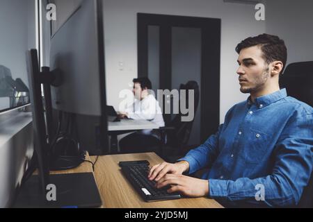 IT Programmer Working on Desktop Computer. Male Specialist Creating Innovative Software Engineer Developing App, Program, Video Game. Terminal with Co Stock Photo