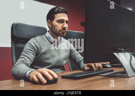 Start up company, young caucasian business people at work, brainstorming ideas, working on computers coding. Colorful offices with young people workin Stock Photo
