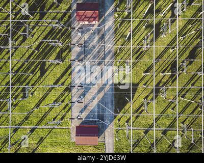 Electrical power substation in the country side of Slovenia. Fields and forests surrounding the power station in the suburbs. Aerial view Stock Photo