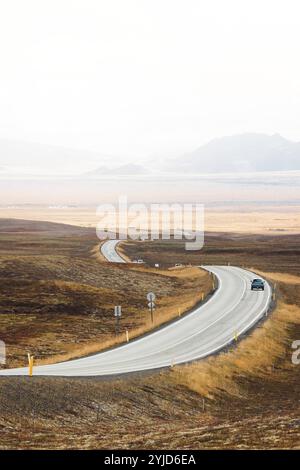 Scenic view on the asphalt road with stones and vegetation on roadsides, selective focus. Stock Photo