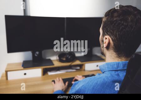 IT Programmer Working on Desktop Computer. Male Specialist Creating Innovative Software Engineer Developing App, Program, Video Game. Terminal with Co Stock Photo