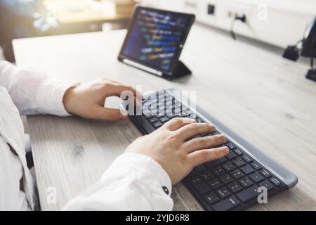 IT Programmer Working on Desktop Computer. Male Specialist Creating Innovative Software Engineer Developing App, Program, Video Game. Terminal with Co Stock Photo