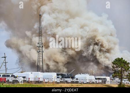 Massive Scrap Yard Fire Smoke Billows Over Tree Line Eye-Level View ...