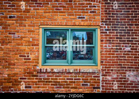 Historic Brick Wall with Reflected Urban Scene at Eye Level Stock Photo