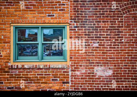 Vintage Brick Wall with Green Window Urban Texture at Eye Level Stock Photo