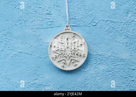 Snowflake Stone Plaster, Plaque Plaster or Concrete. Enhanced durability to frost when hardened. Concrete, Gypsum Christmas ball on blue textured gyps Stock Photo