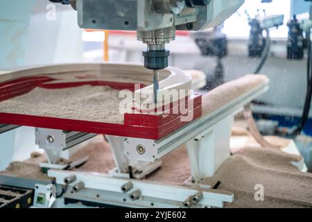 Manufacture of wooden furniture on a CNC machine in production. Woodworking. High quality photo Stock Photo