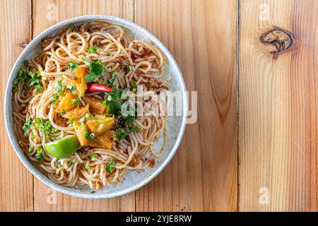 The Khao Soi Yuan Naan that is served on the plate is Khao Soi noodles mixed with minced pork spring onion coriander and chili lime and sesame spicy a Stock Photo