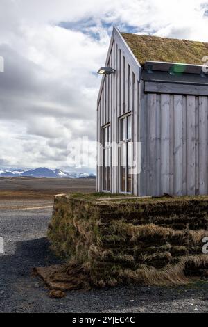 Traditional Icelandic wooden building with turf covered roof, grey wooden panels. Stock Photo