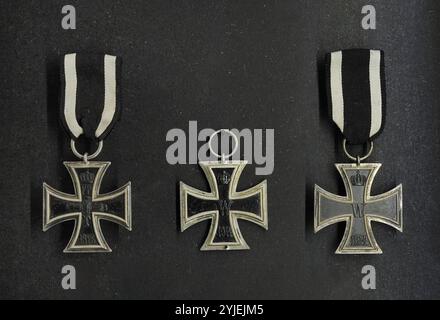 Iron Cross. Military decoration in the Kingdom of Prussia, German Empire (1871-1918) and Nazi Germany (1933-1945). Iron Crosses 2nd Class (most common, awarded for acts of bravery on the battlefield). From left to right: Iron Cross designed in 1813 (Napoleonic Wars) and Iron Crosses designed in 1914 (World War I). Latvian War Museum. Riga. Latvia. Stock Photo