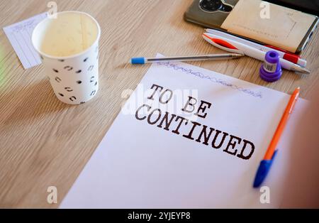 To be continued word written on wood block. To be continued text on cement table for your desing, concept. Stock Photo