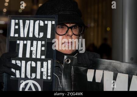London, UK. 8th February 2018. Class War protest outside The Shard this evening after defeating the attempt by lawyers representing the Qatari Royal Family who own the building to take out an injunction to prevent their protest. The protest was at the Shard as there are said to be ten £50 million pound apartments there which have remained empty since the building was completed at a time when London has a huge housing crisis with so many homeless and sleeping on the street. Class War aim to highlight the huge number of empty properties in London where there are so many large development of high Stock Photo