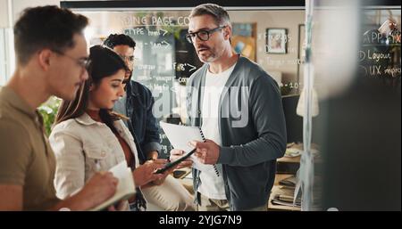 Business people, web developers or meeting with project for planning, brainstorming or schedule at office. Group, designers or content creator with Stock Photo
